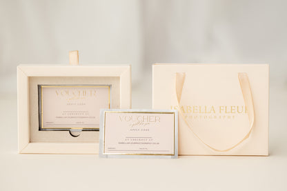 Voucher card, photo frame, and gift box with 'Isabella Fleur' branding on a light background