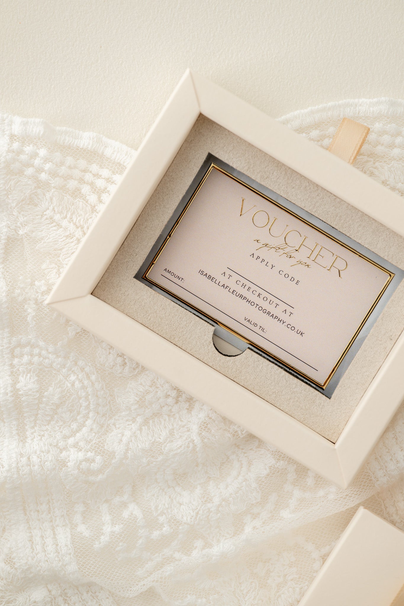 Gift voucher in a decorative box on a textured white surface