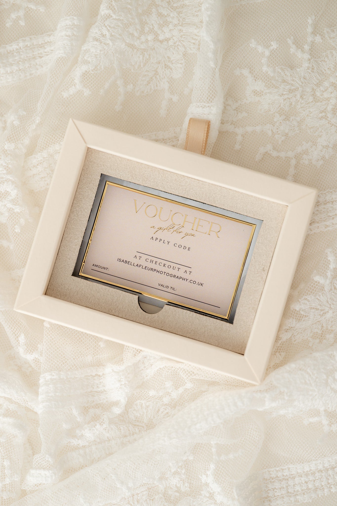 Gift voucher in a decorative box on a textured white surface
