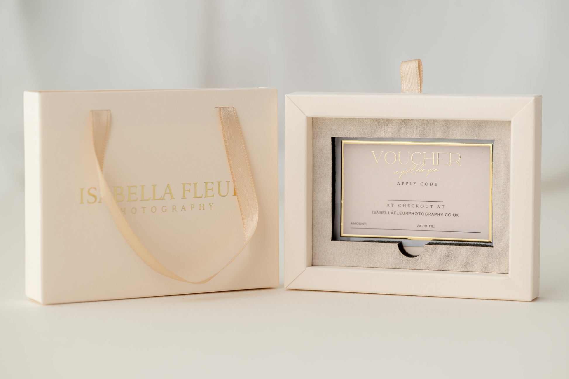 Cream-colored gift voucher and packaging with 'Isabelle Fleur' branding on a light gray background