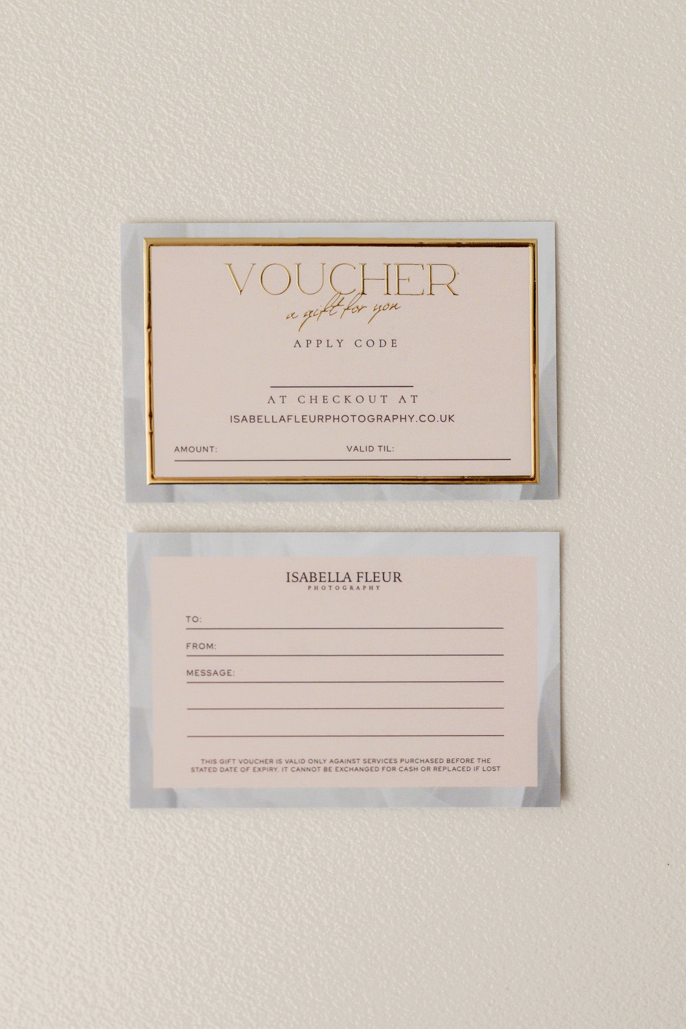 Two gift vouchers on a textured beige background